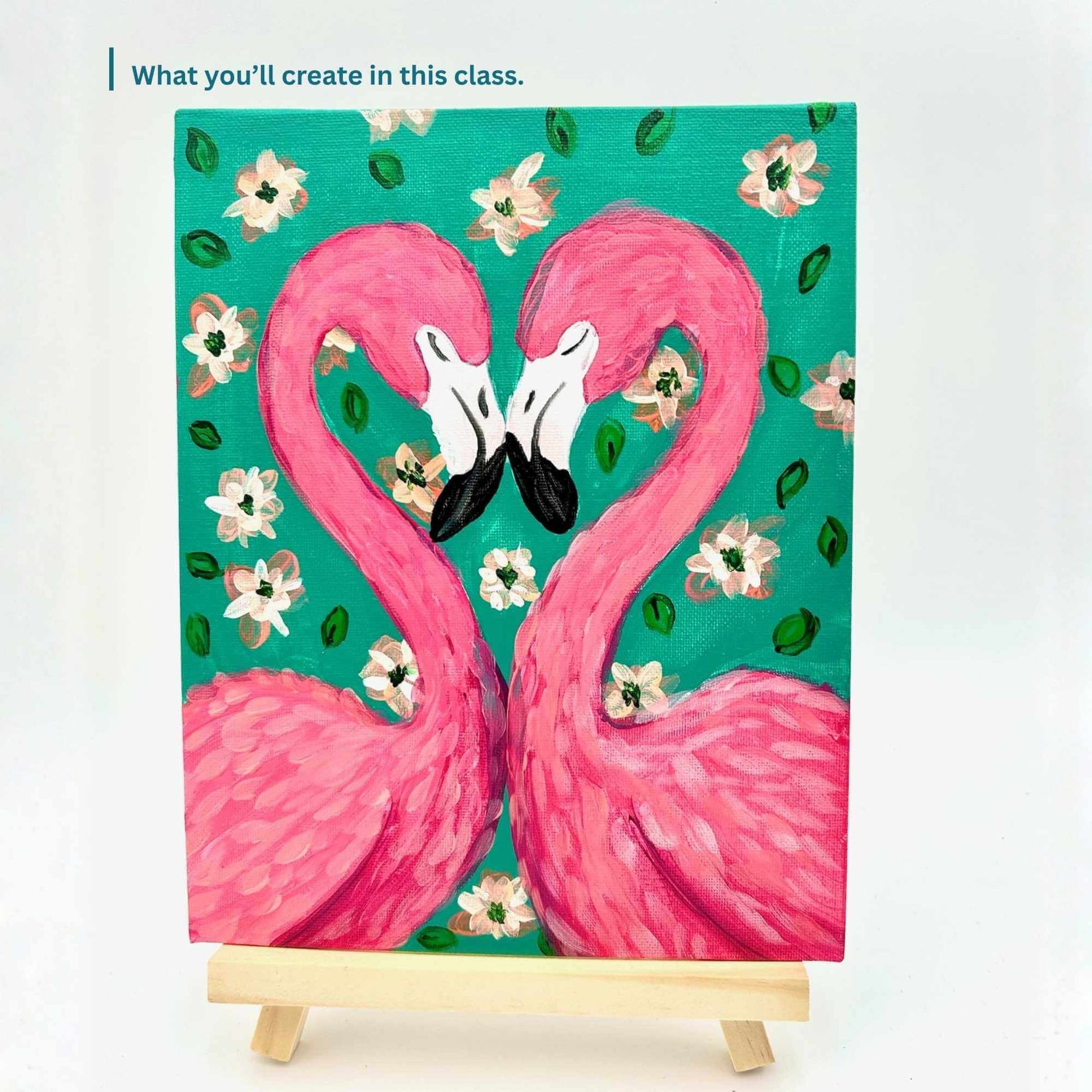 Painting of two pink flamingos on a teal background with flowers, on a small easel.