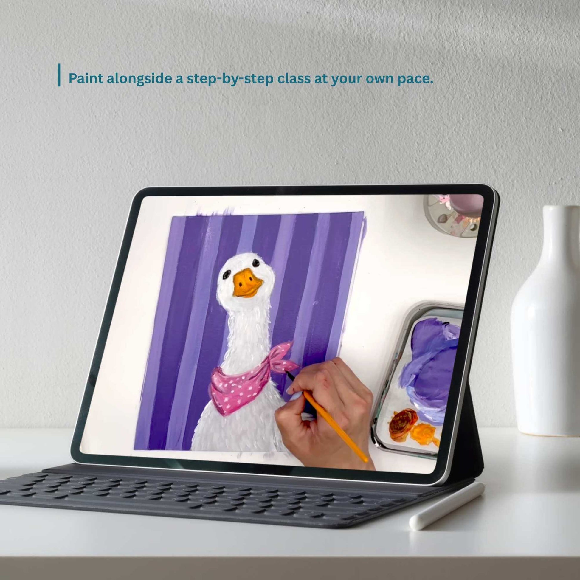 Tablet displaying a painting of a duck with a pink bow, on a white surface with a vase in the background.