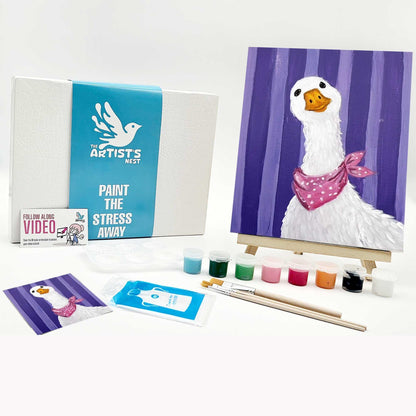 Artistic painting kit with a duck painting on an easel, paint supplies, and branded materials.
