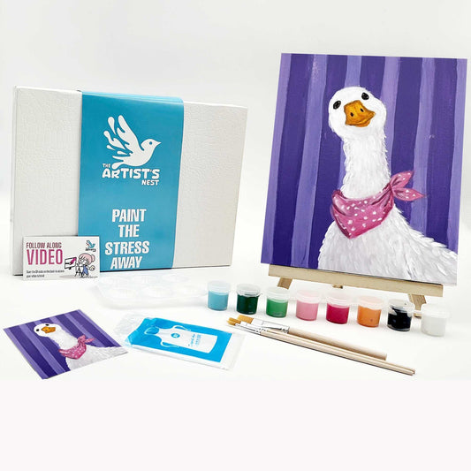 Artistic painting kit with a duck painting on an easel, paint supplies, and branded materials.