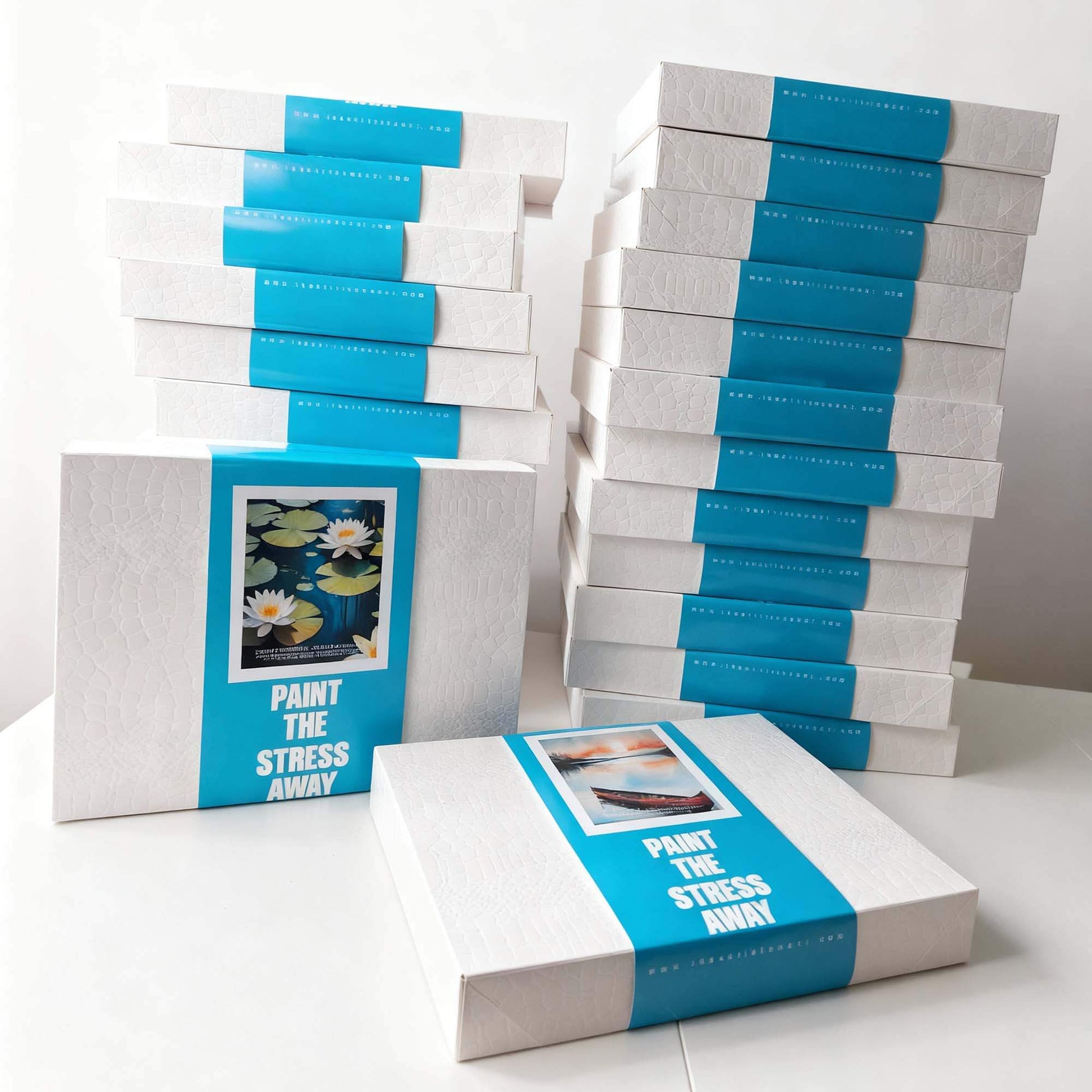 Stacks of 'Paint the Stress Away' art kits on a white surface with a light gray background.